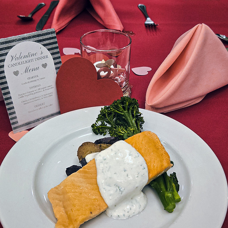 Chef-prepared court-bouillon poached salmon with dill yogurt cream sauce, fingerling potatoes and broccolini at The Wellington Senior Living.
