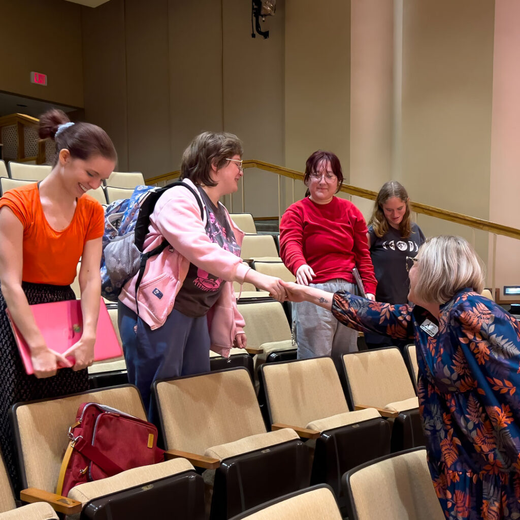 Elizabeth Thompson greets college students after a live Thoughtful Connections memory care podcast recording at Cottey College.